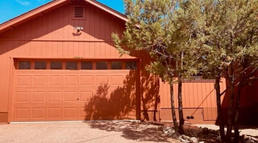 attached garage with graveled drive