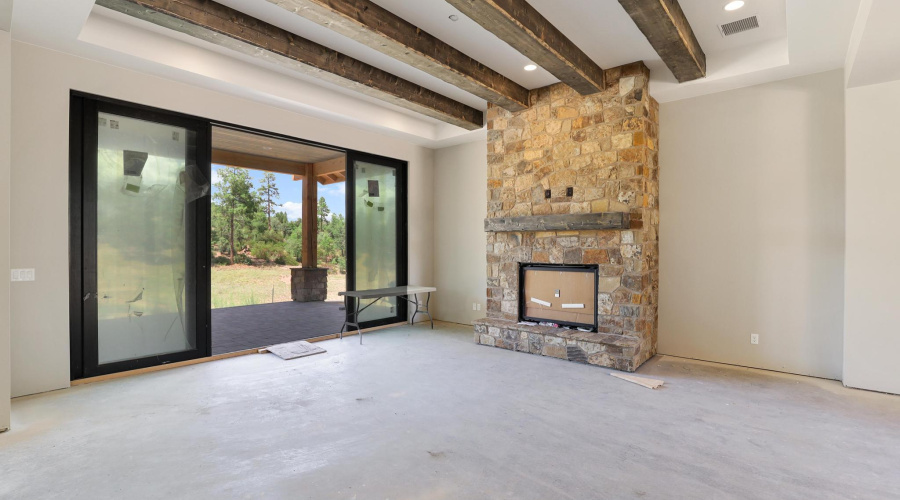 Great Room with Beamed Ceiling and Stone