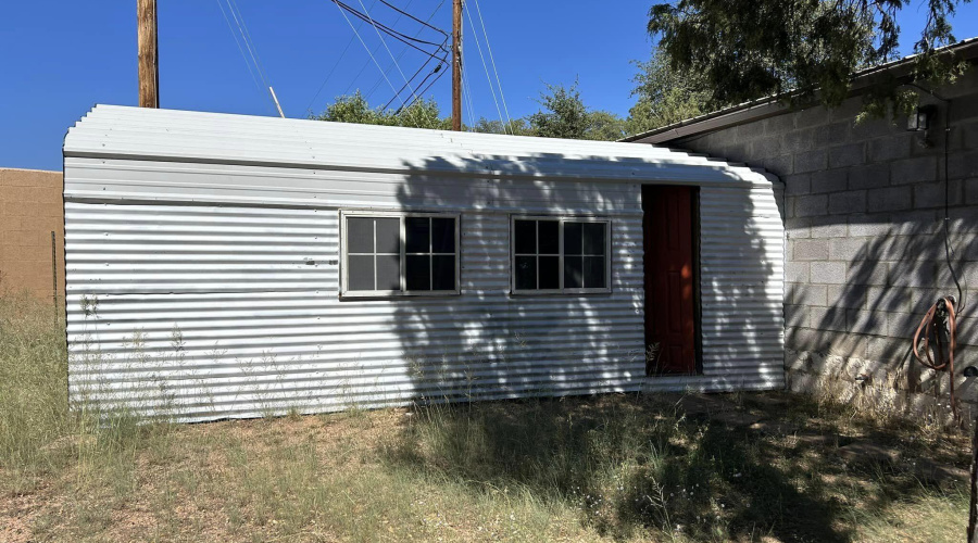 mini shed with garage door  dirt floor