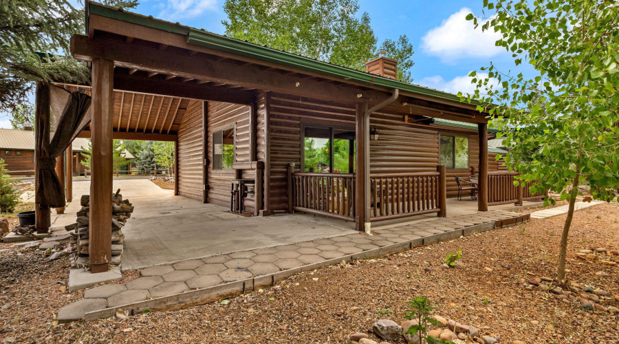 LOOKING FROM BACK YARD THROUGH CARPORT