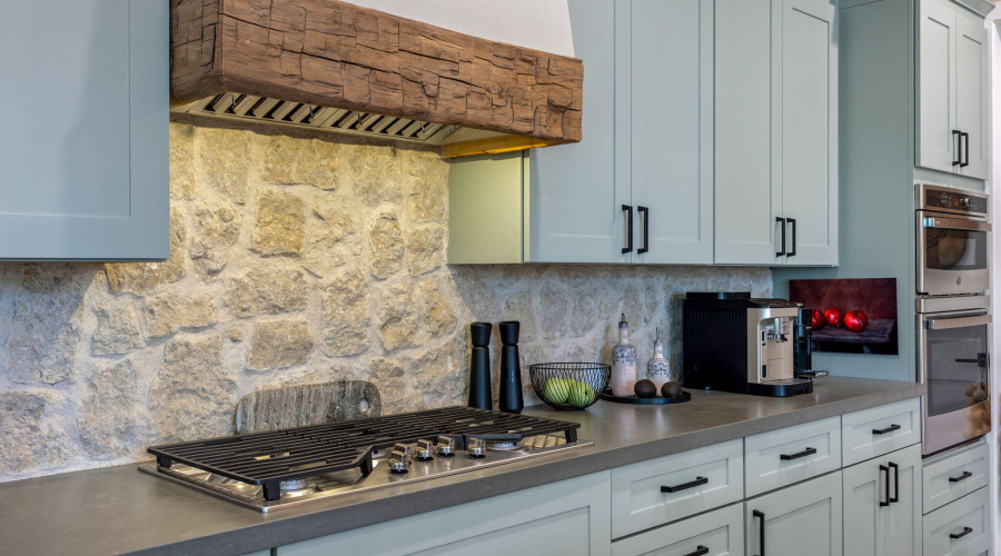 Limestone backsplash and imported beam