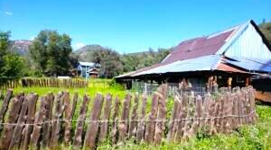 Barn with Homes in Background