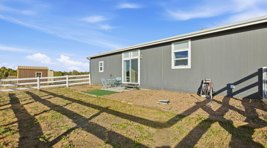 Fenced in area behind home