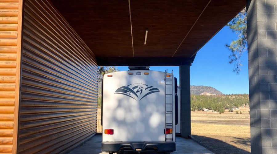 RV in forested parking area
