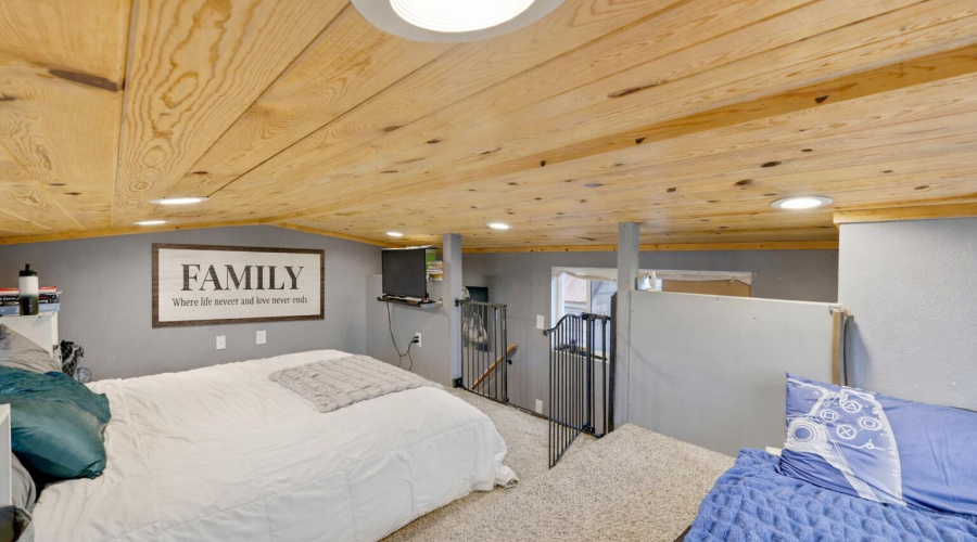 Cozy loft bedroom with family art