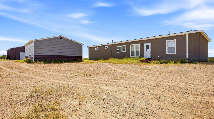 View of back of home & 2-car garage