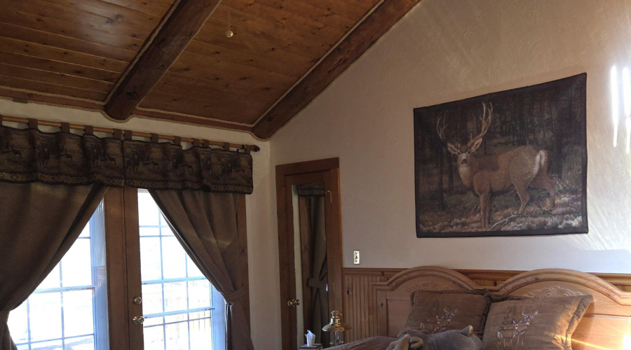 primary bedroom toward doors to deck