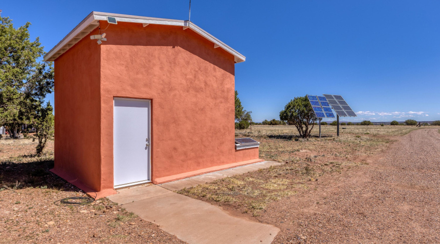 Utility shed, solar and water tank.